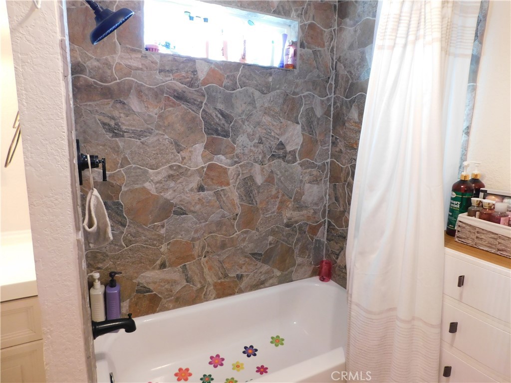 10350 Baseline, Unit 55 Alta Loma, CA 91701 - Photo 31 of 53 a bathroom with a bathtub and shower