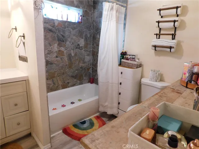 a bathroom with a toilet a sink and a mirror