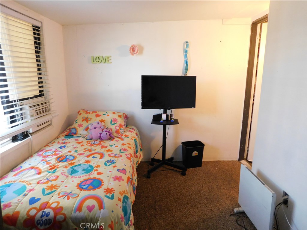 10350 Baseline, Unit 55 Alta Loma, CA 91701 - Photo 41 of 53 a bedroom with a bed and a flat tv screen on the dresser