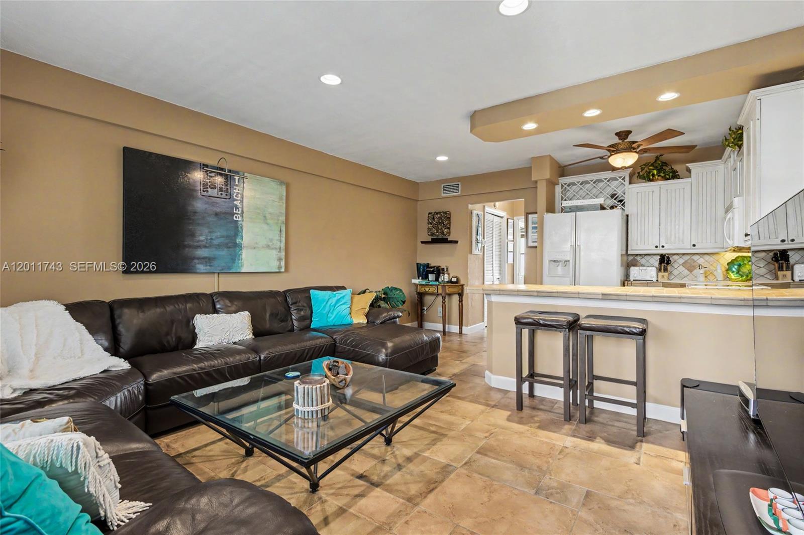 1801 South Surf Road, Unit 2G Hollywood, FL 33019 - Photo 11 of 32 a living room with furniture and a flat screen tv