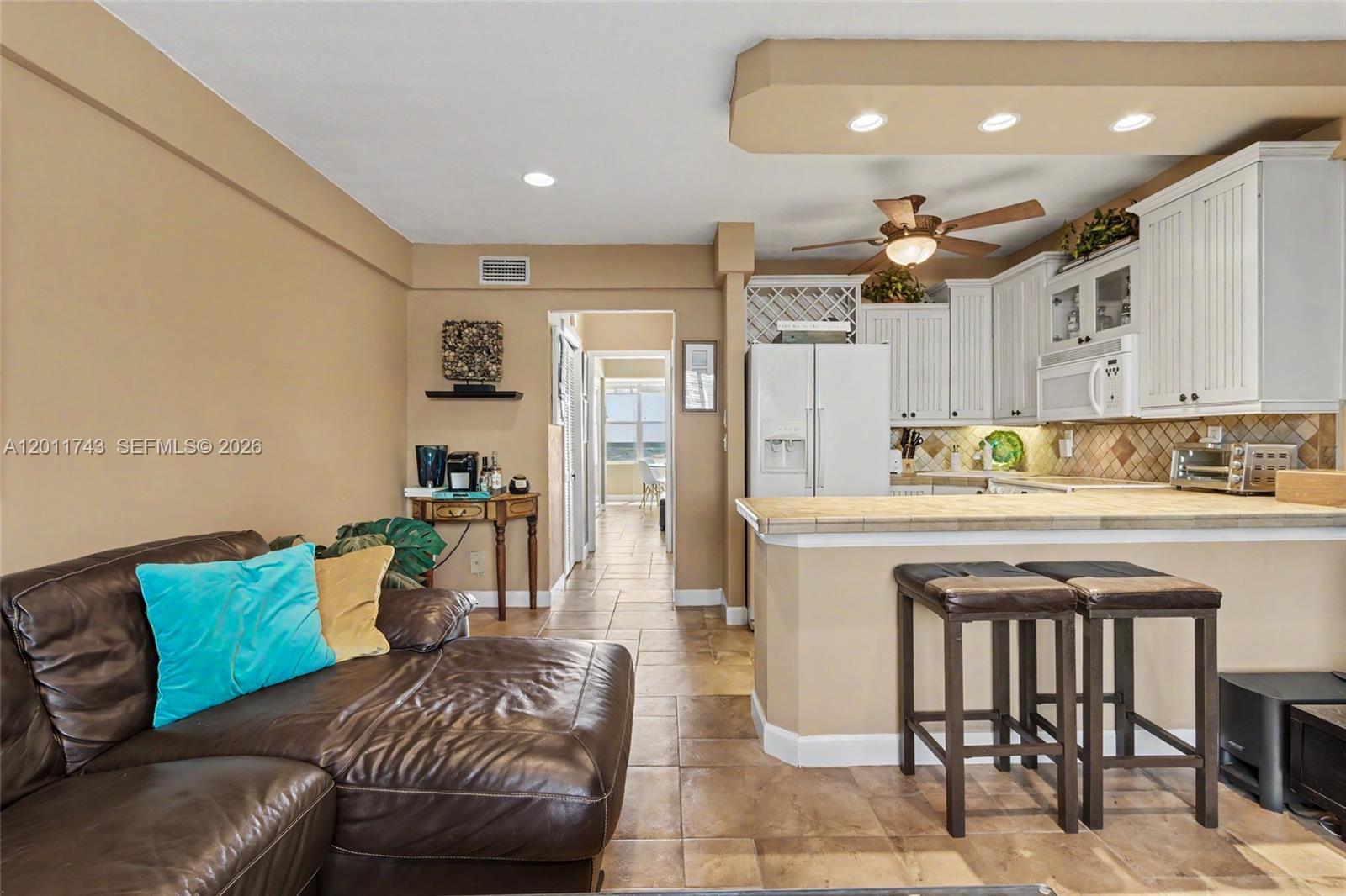 1801 South Surf Road, Unit 2G Hollywood, FL 33019 - Photo 12 of 32 a kitchen with stainless steel appliances granite countertop a sink and a refrigerator