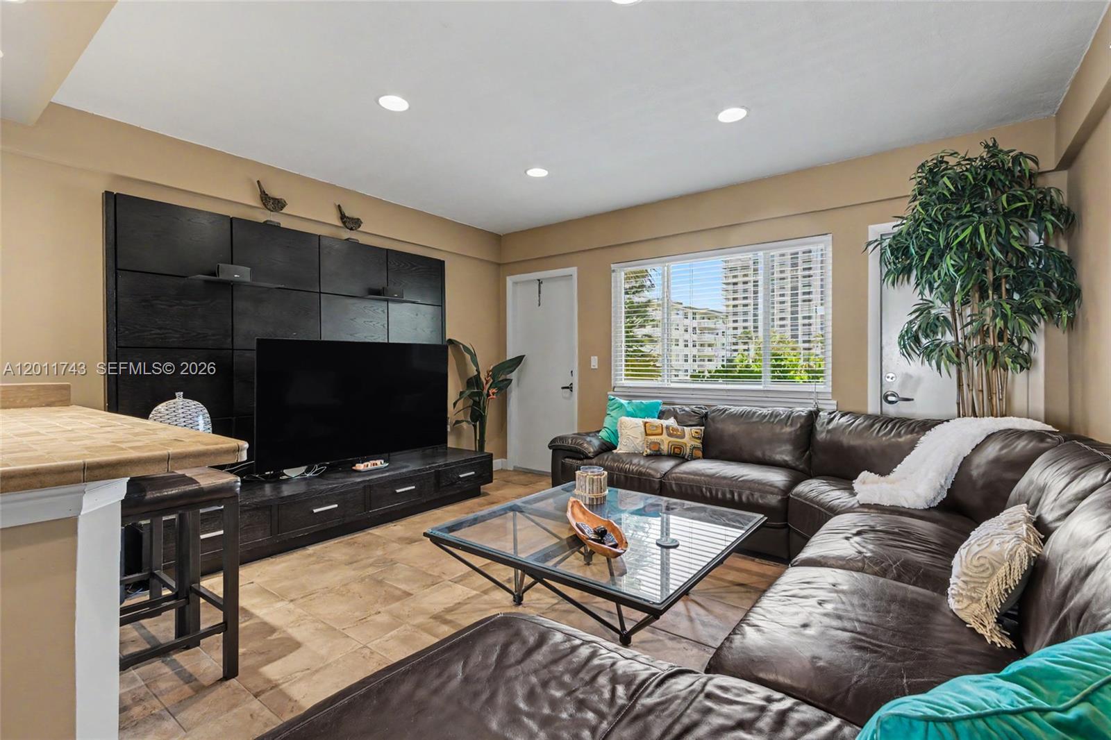 1801 South Surf Road, Unit 2G Hollywood, FL 33019 - Photo 14 of 32 a living room with furniture and a flat screen tv