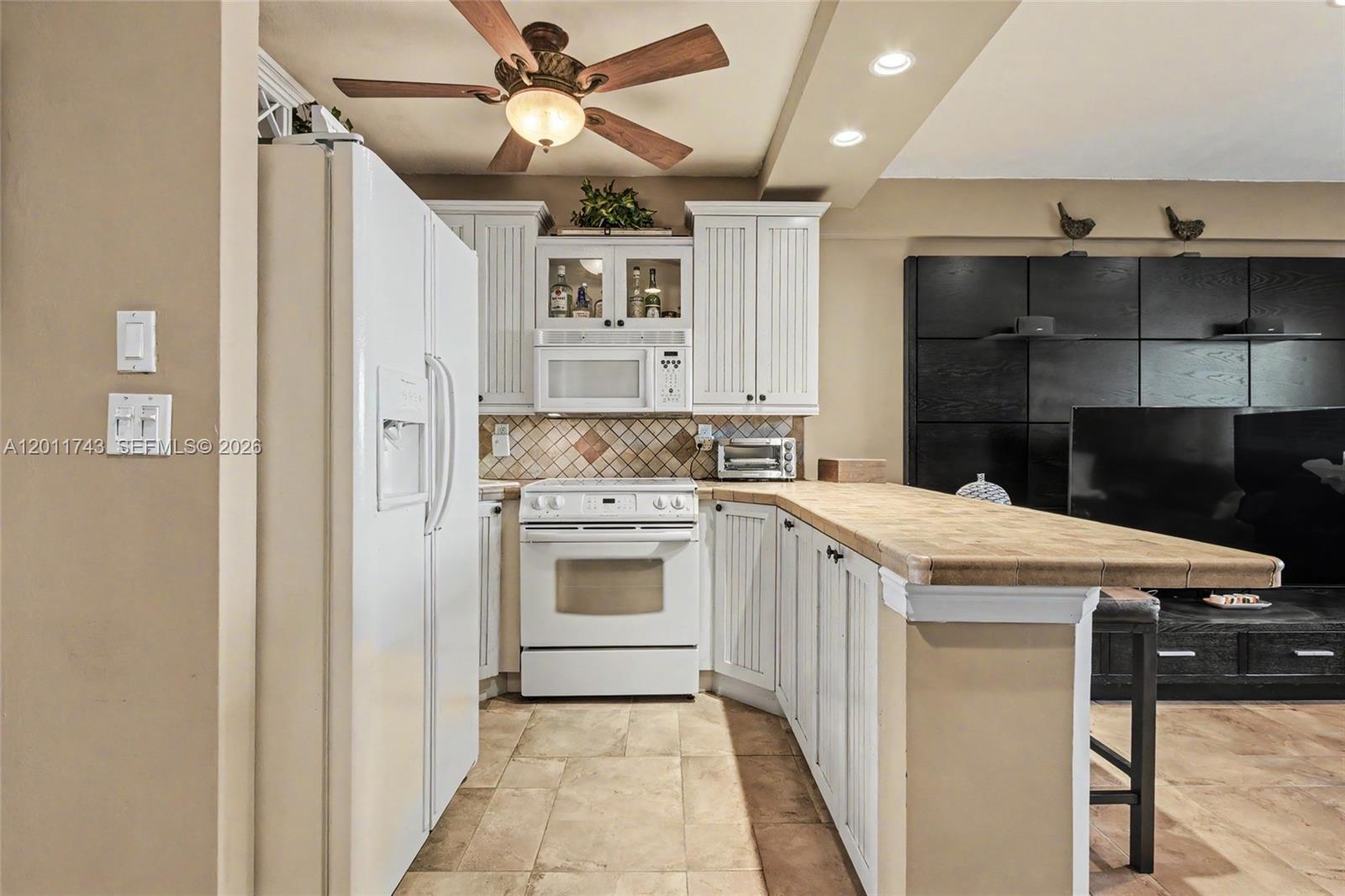 1801 South Surf Road, Unit 2G Hollywood, FL 33019 - Photo 18 of 32 a kitchen with a stove sink and cabinets