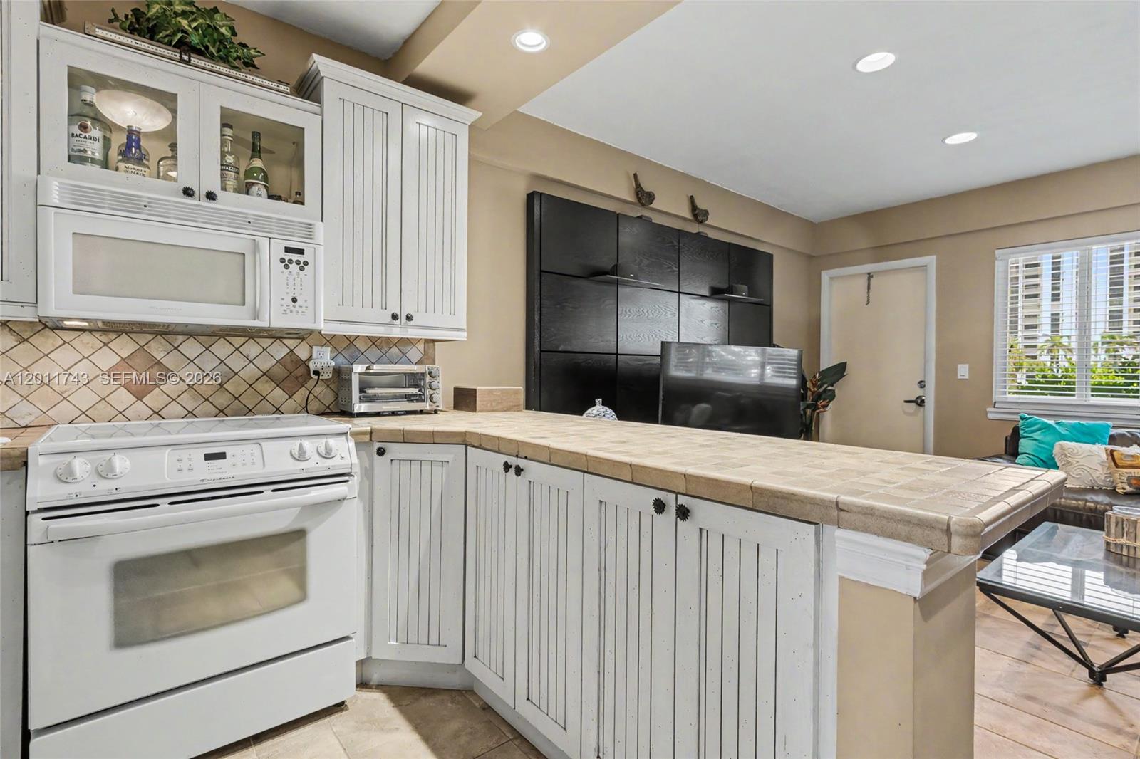 1801 South Surf Road, Unit 2G Hollywood, FL 33019 - Photo 21 of 32 a kitchen with cabinets appliances and wooden floor