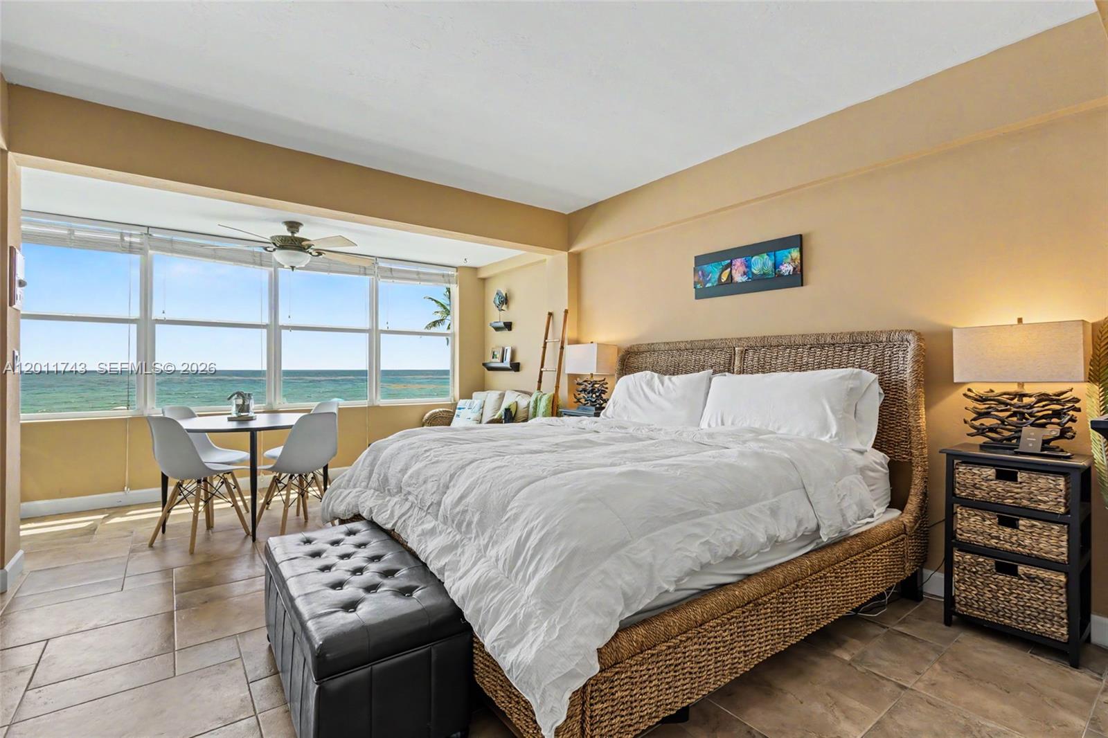 1801 South Surf Road, Unit 2G Hollywood, FL 33019 - Photo 22 of 32 a bedroom with a bed and a table with the view of bathroom