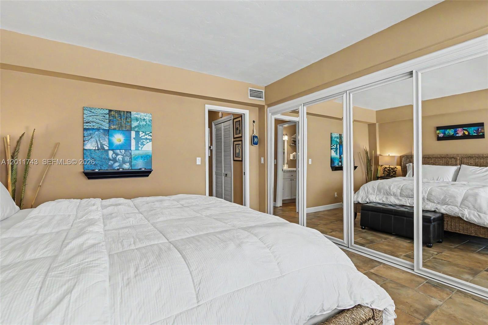 1801 South Surf Road, Unit 2G Hollywood, FL 33019 - Photo 27 of 32 a bedroom with a large bed and a walk in closet