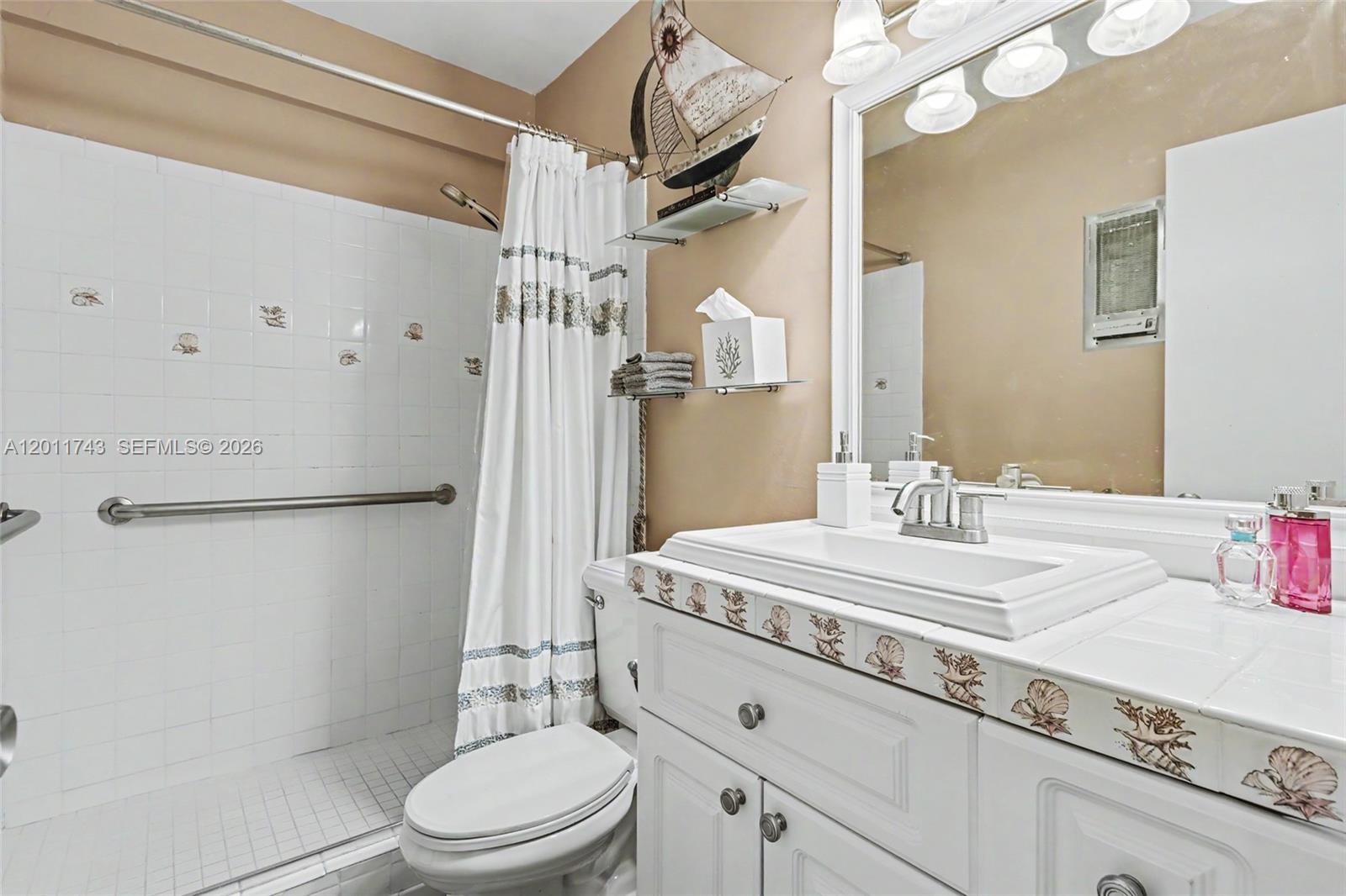 1801 South Surf Road, Unit 2G Hollywood, FL 33019 - Photo 30 of 32 a bathroom with a sink a toilet and shower
