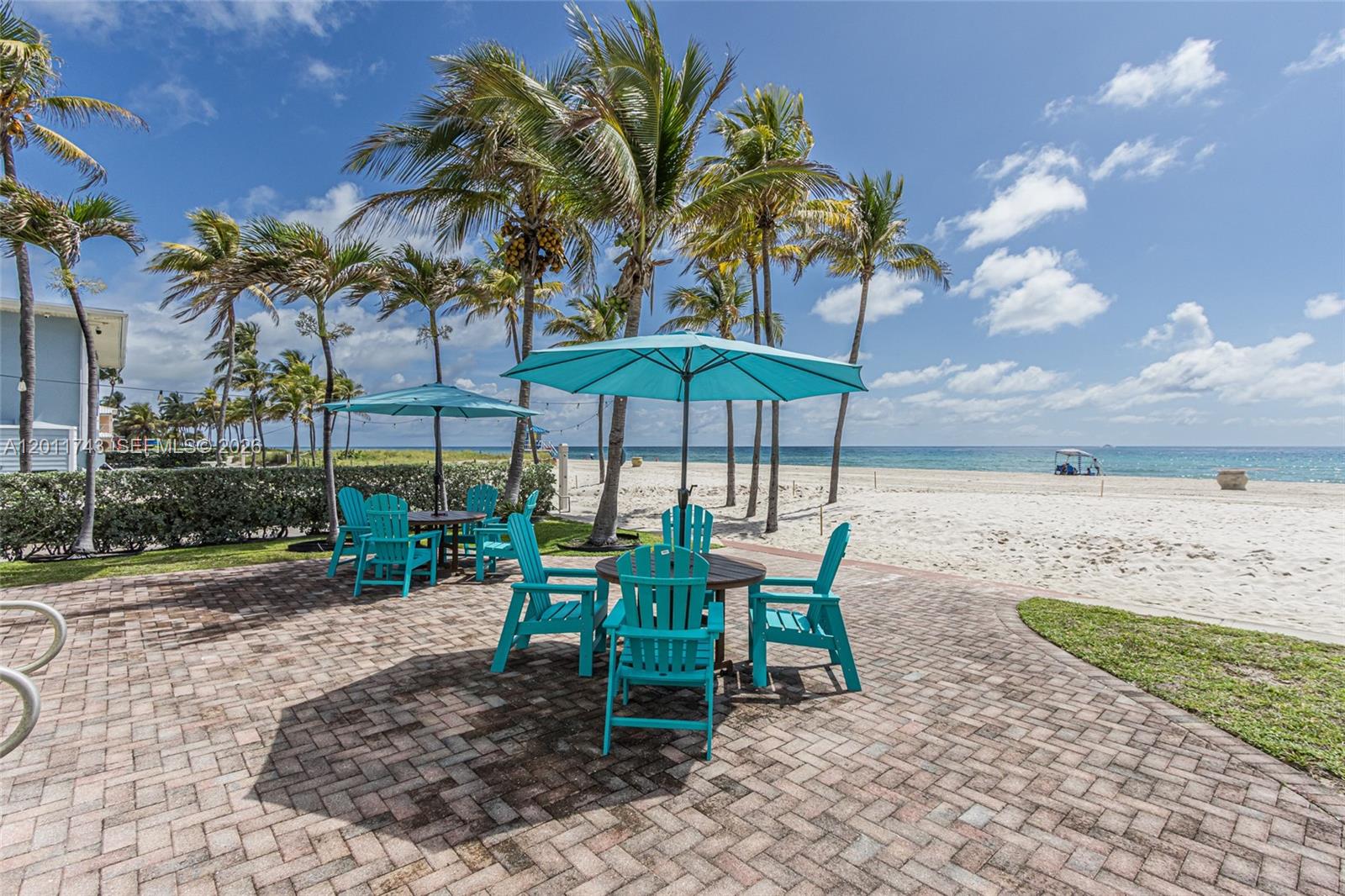 1801 South Surf Road, Unit 2G Hollywood, FL 33019 - Photo 4 of 32 a view of a table and chairs under an umbrella in patio