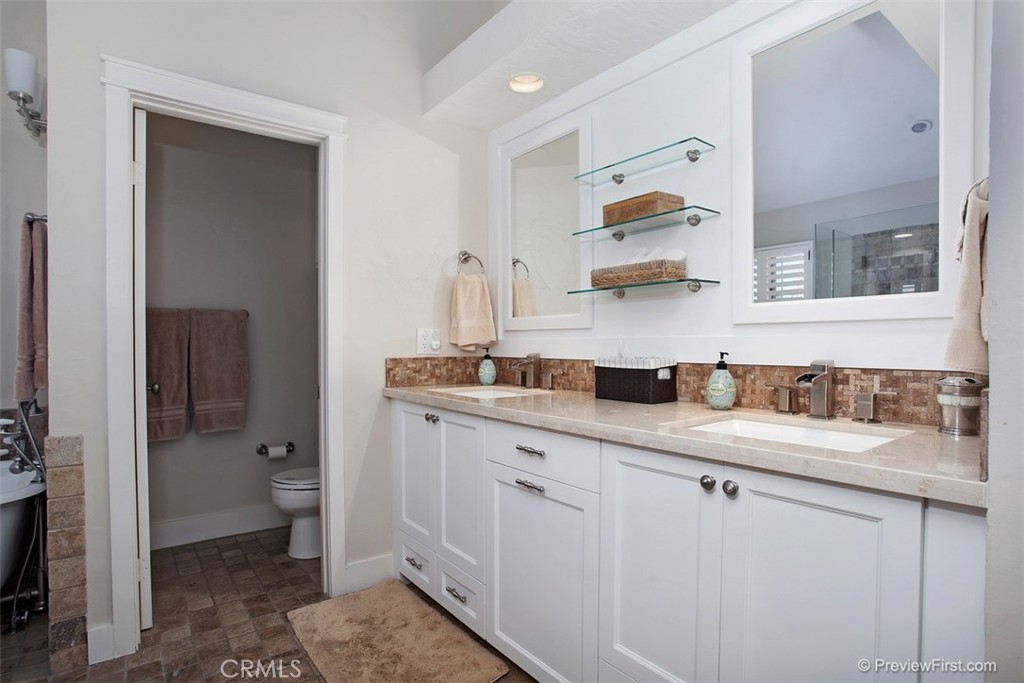 441 Carnation Avenue Corona del Mar, CA 92625 - Photo 11 of 25 a kitchen with white cabinets and sink