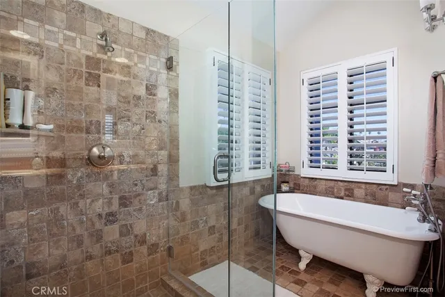 a bathroom with a bathtub and next to a window