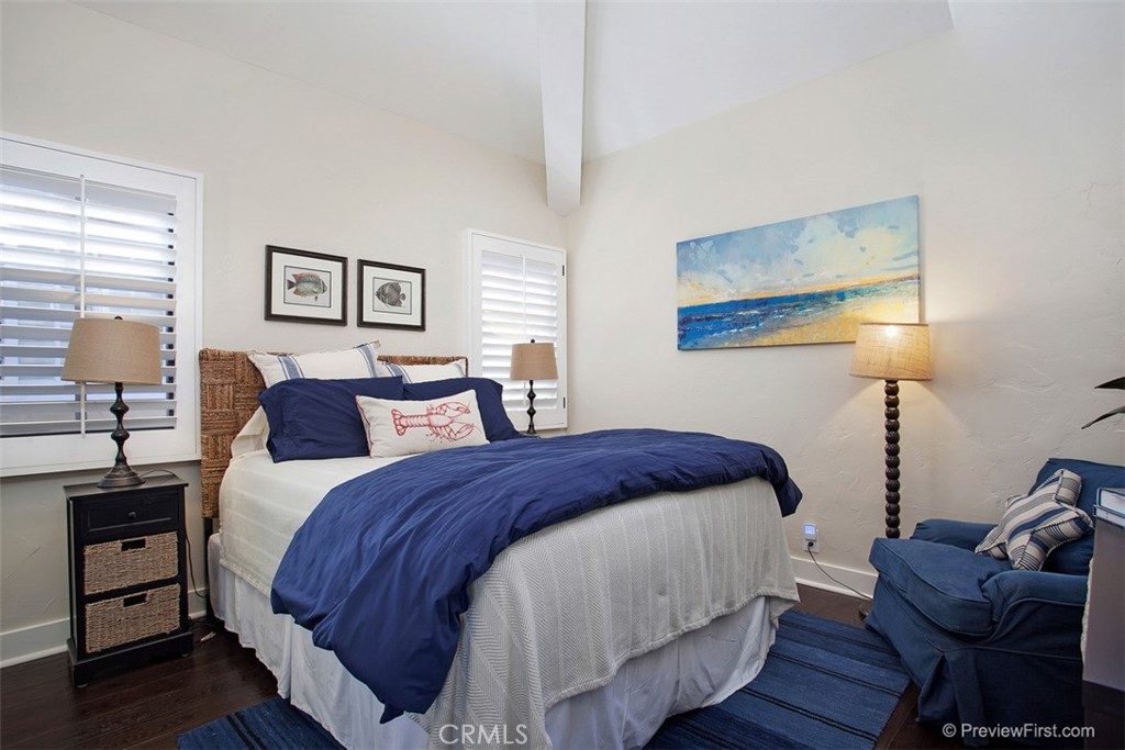 441 Carnation Avenue Corona del Mar, CA 92625 - Photo 14 of 25 a bedroom with a bed and wooden floor