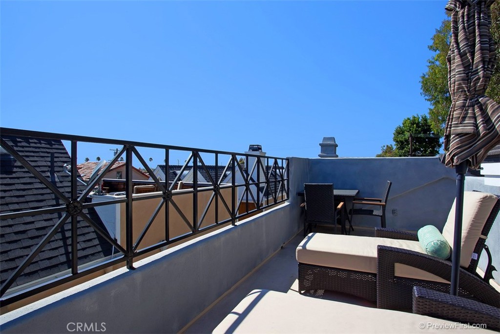 441 Carnation Avenue Corona del Mar, CA 92625 - Photo 18 of 25 a view of a balcony with furniture