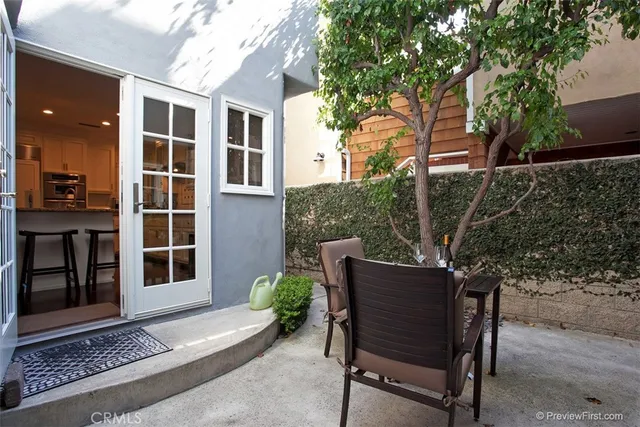 a wooden bench sitting in front of a building
