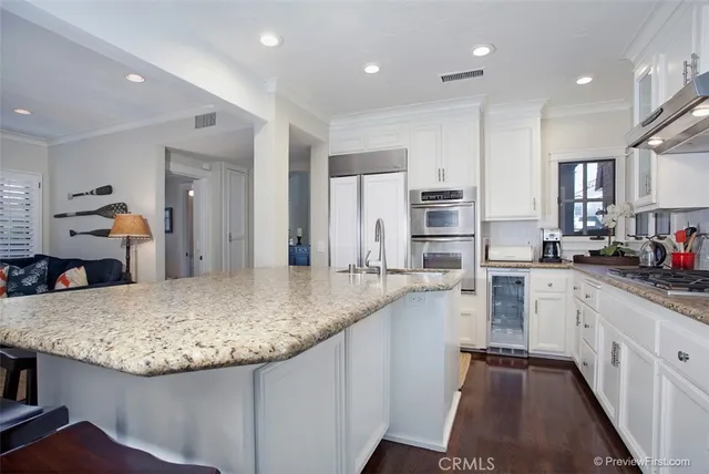 a kitchen with center island and stainless steel appliances
