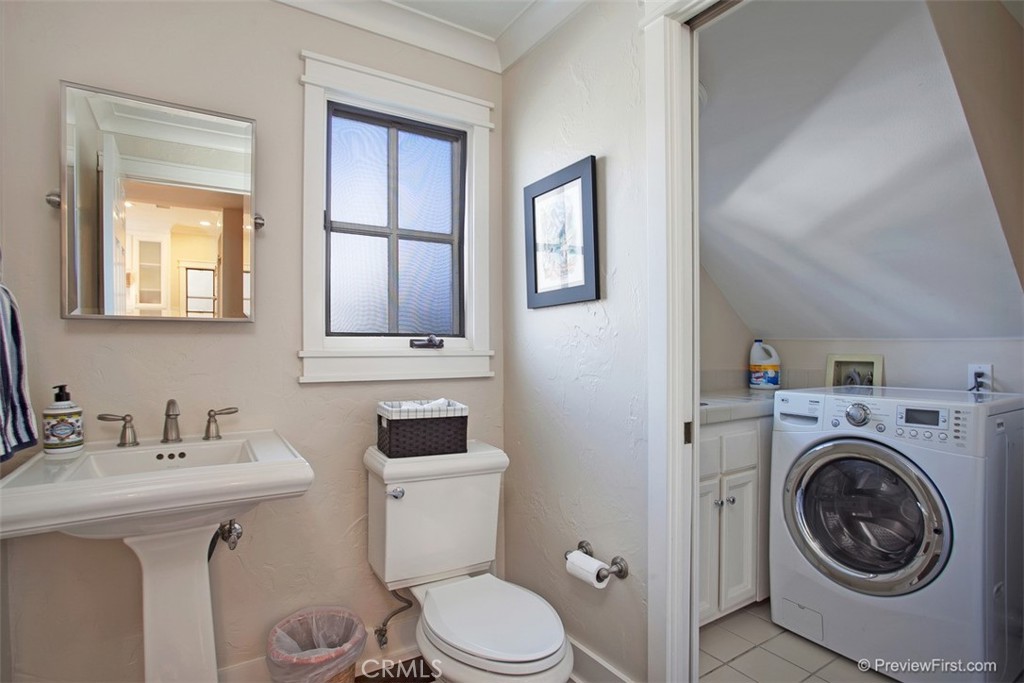 441 Carnation Avenue Corona del Mar, CA 92625 - Photo 9 of 25 a bathroom with a toilet sink and mirror