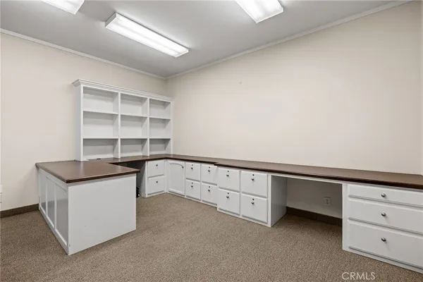 a kitchen with granite countertop white cabinets and sink
