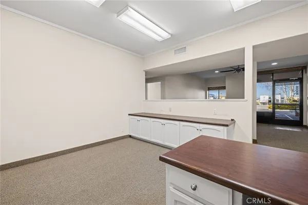 a room with a table chairs and wooden floor