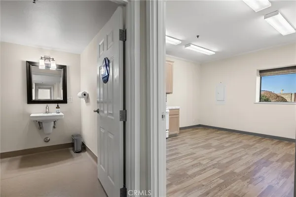a kitchen with wooden floors and white appliances