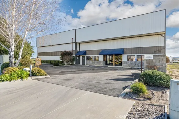 a view of a street with potted plants