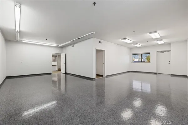 an empty room with a empty space and windows