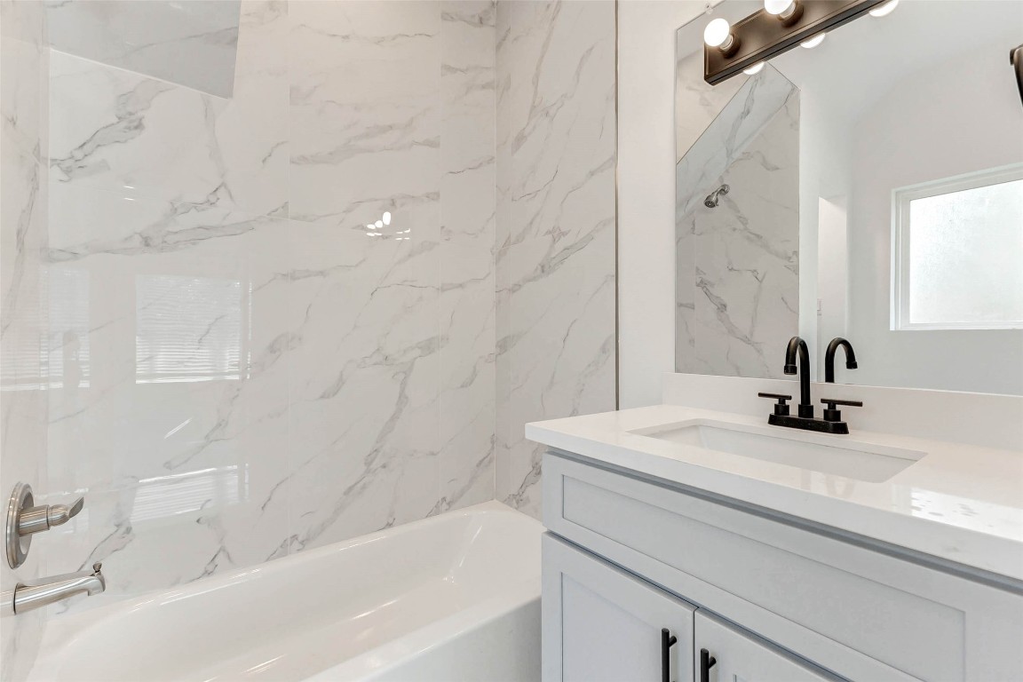 6017 Beall Street Houston, TX 77091 - Photo 22 of 33 a bathroom with a sink a bathtub and a shower
