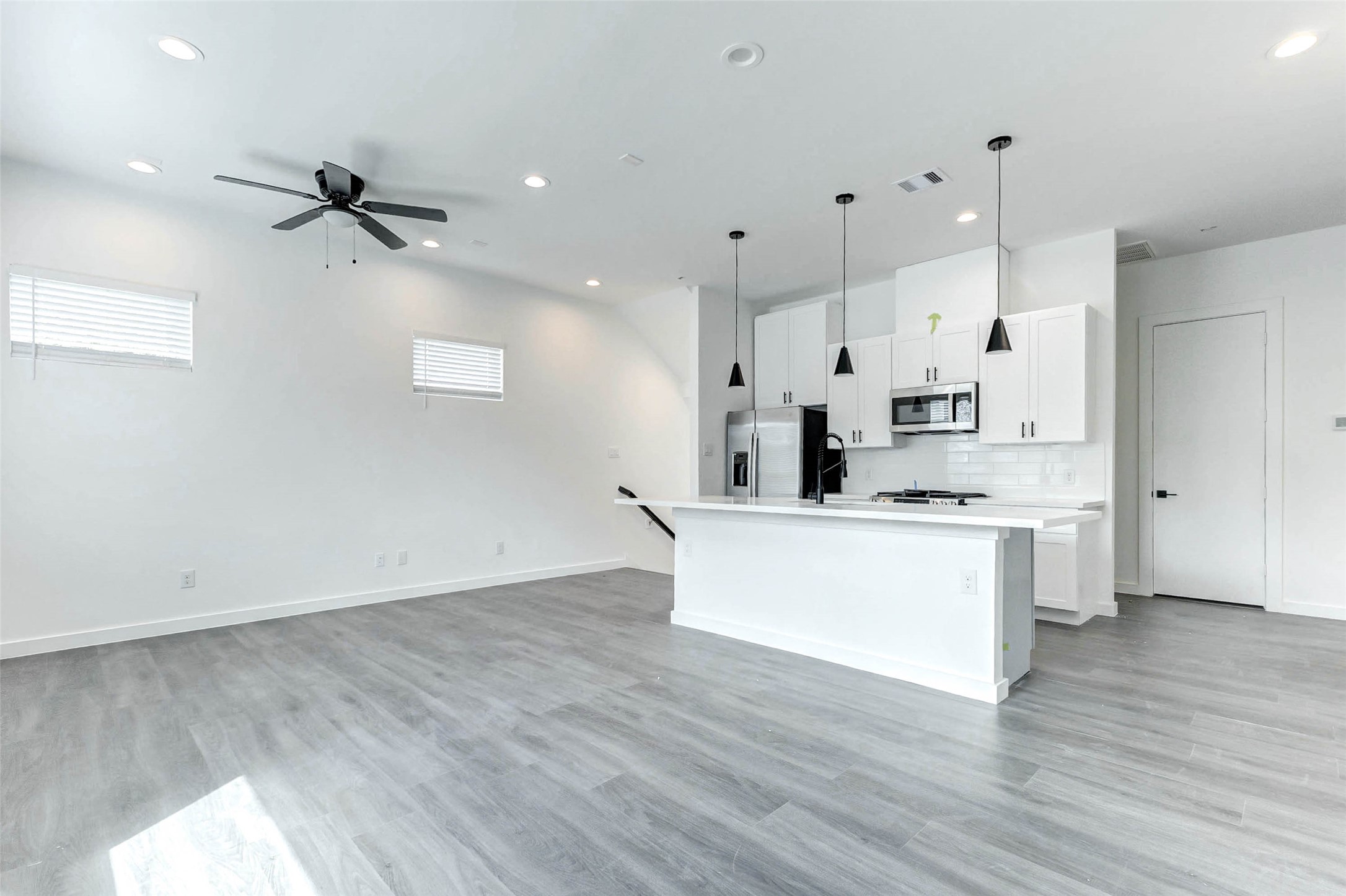 6017 Beall Street Houston, TX 77091 - Photo 9 of 29 Bright, open, and beautifully designed! This spacious main level features a modern kitchen with a massive quartz island, recessed lighting, and a seamless flow into the living space ideal for entertaining or relaxed everyday living.