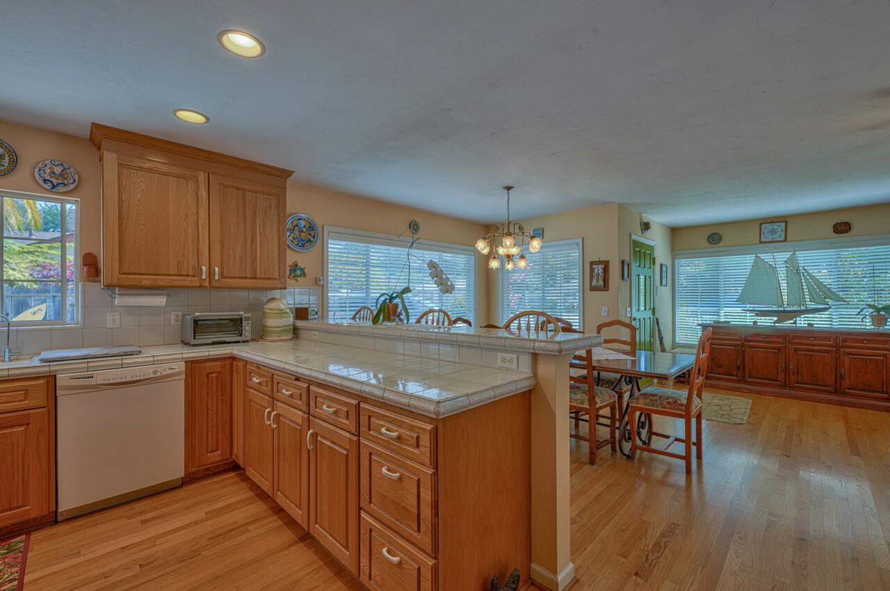 26382 Riverside Place Carmel, CA 93923 - Photo 12 of 29 a kitchen with stainless steel appliances granite countertop wooden floors and white cabinets