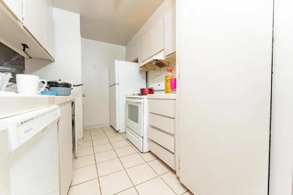 a utility room with cabinets washer and dryer