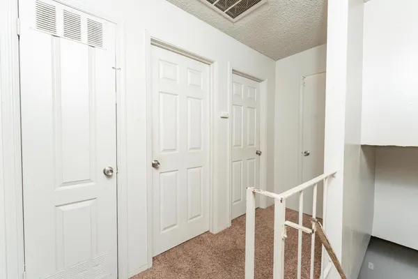 a view of a hallway with wooden floor and entryway