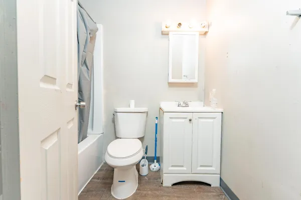 a bathroom with a toilet a sink and a mirror