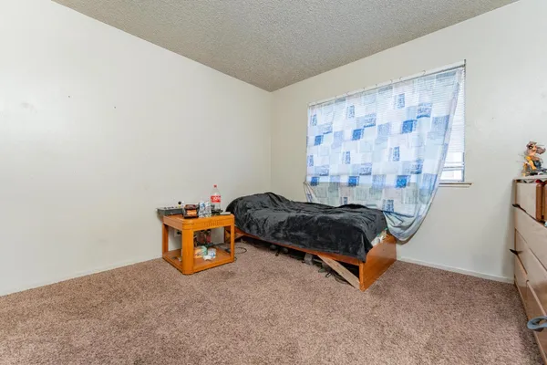 a bedroom with a bed and window