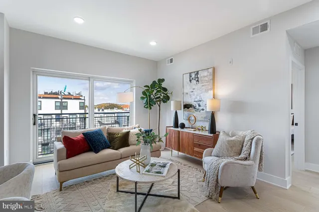 a living room with furniture a dining table and kitchen view
