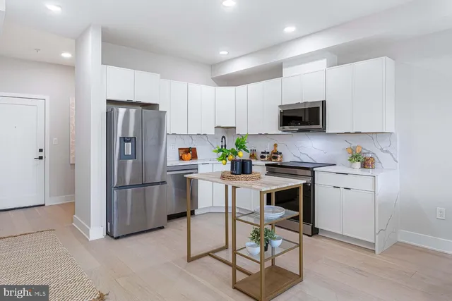 a kitchen that has a lot of cabinets in it and appliances