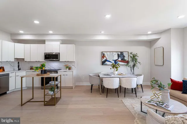 a kitchen with granite countertop white cabinets and a stove top oven