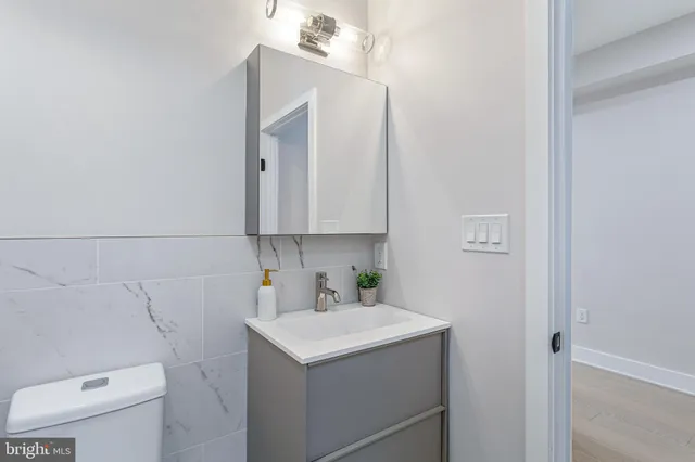 a view of a hallway with potted plants on a table