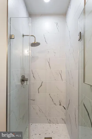 a bedroom with a bed a couch and a window