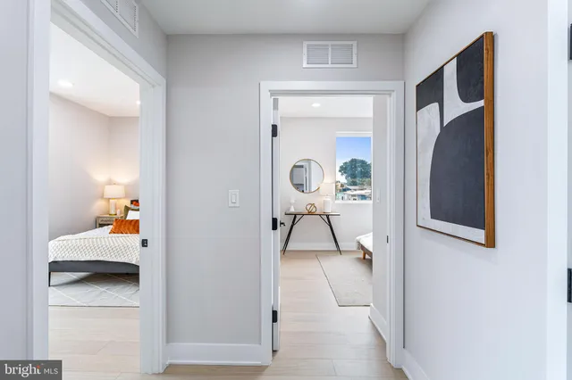 a bathroom with a granite countertop sink a toilet and vanity