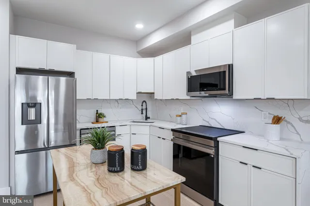 a view of a hallway with washer and dryer