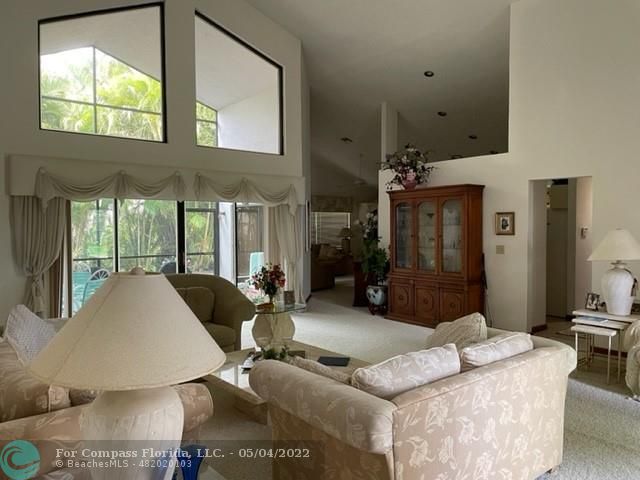 Oaktree Estates Oakland Park, FL 33309 - Photo 5 of 17 a living room with furniture and a large window