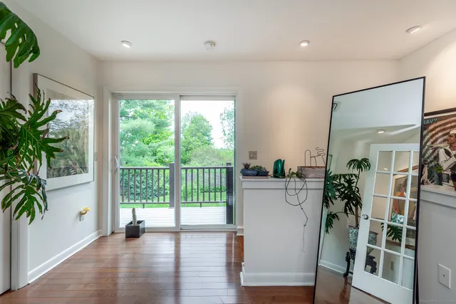 a view of entryway and hall with wooden floor