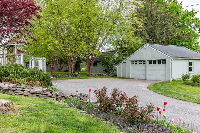 a house with green field in front of it