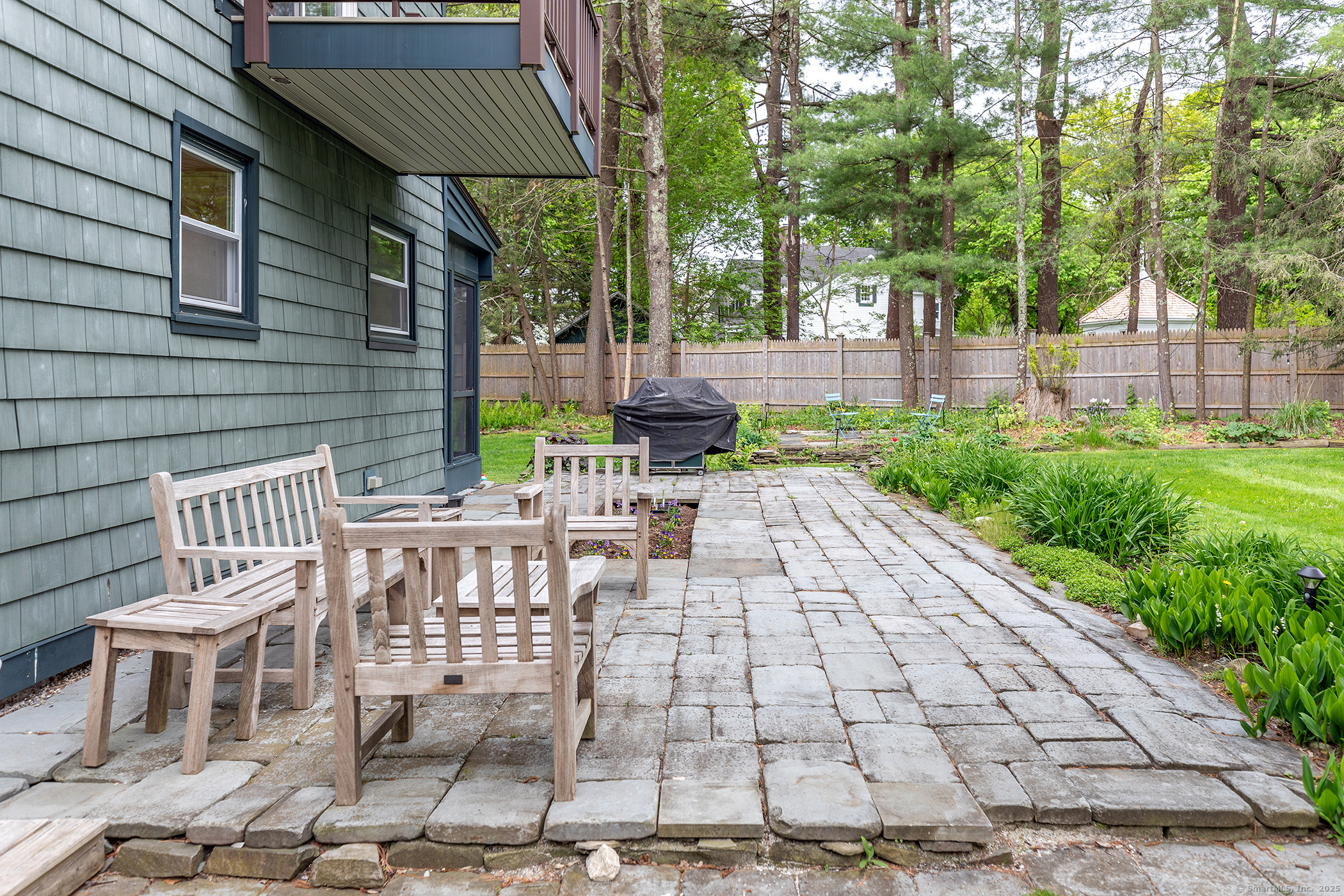 17 Rhynus Road Sharon, CT 06069 - Photo 28 of 30 a view of a patio with table and chairs with wooden fence and plants