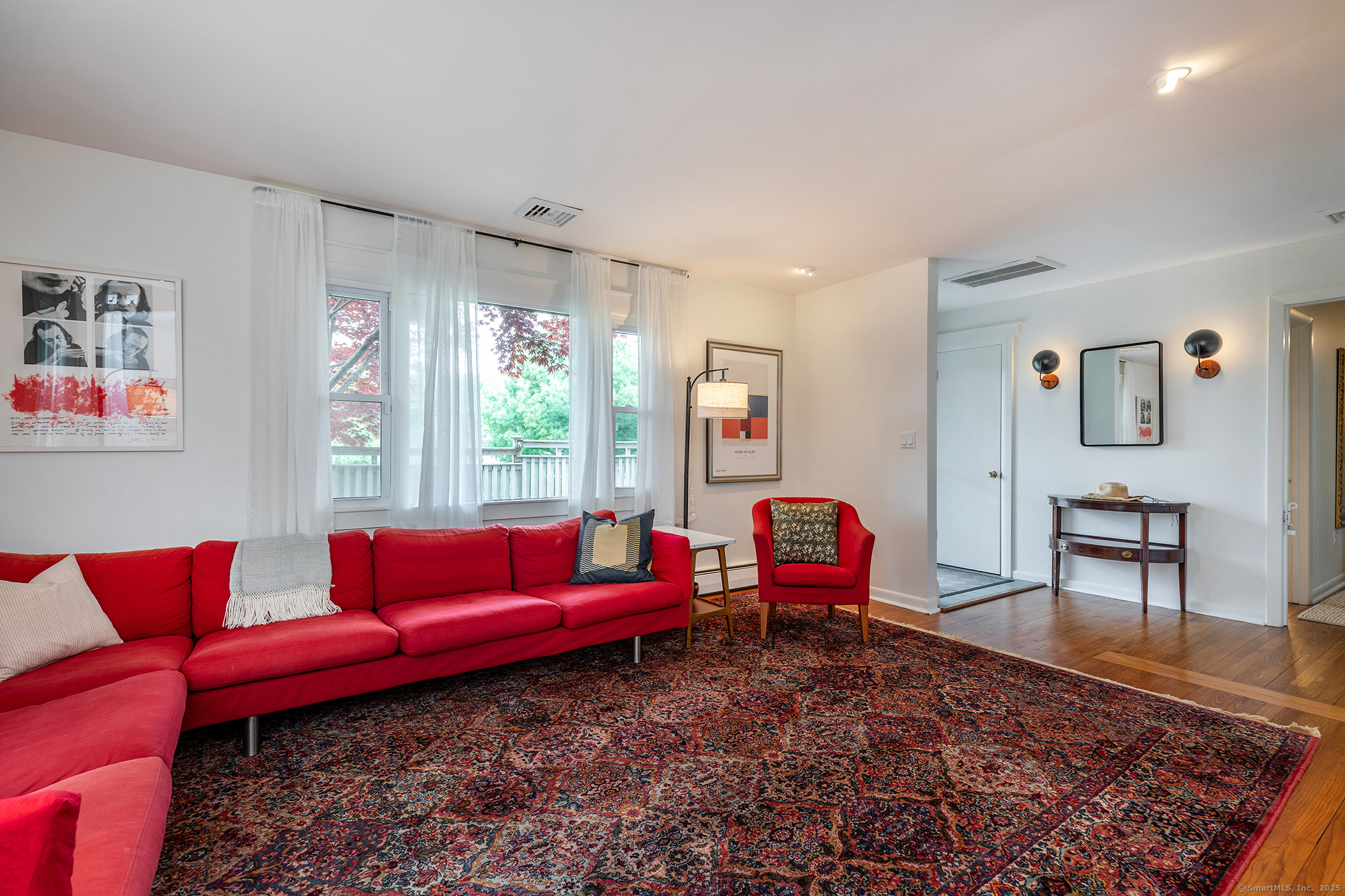 17 Rhynus Road Sharon, CT 06069 - Photo 4 of 30 a living room with furniture red walls and a rug