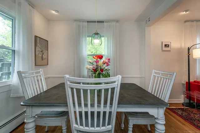 a view of a dining room with furniture wooden floor and window