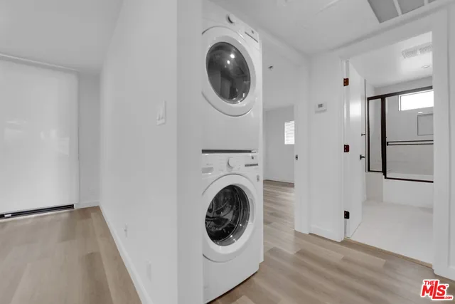a view of a hallway with washer and dryer