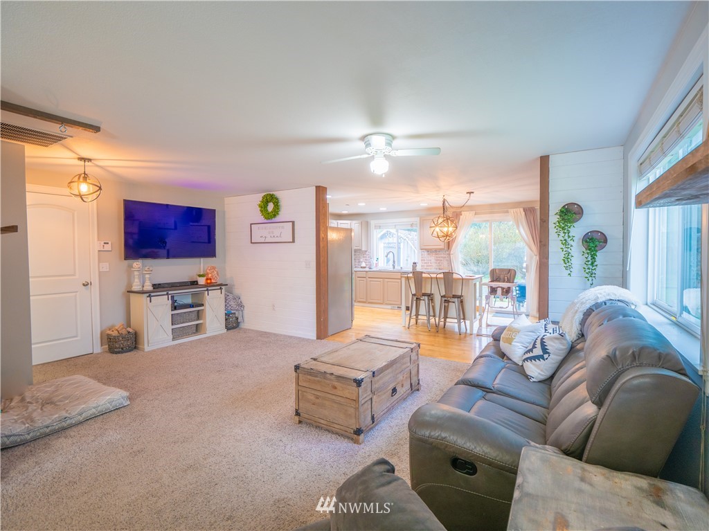 12607 Mundy Loss Road Buckley, WA 98321 - Photo 8 of 25 a living room with furniture and a chandelier