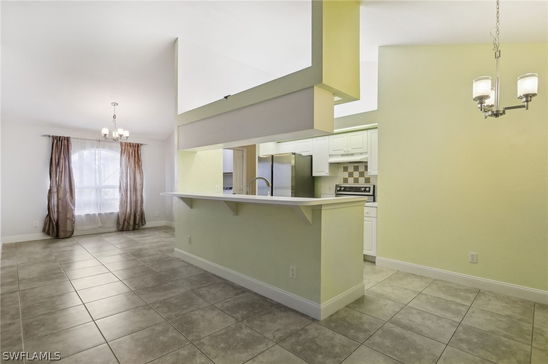 18364 Camellia Road Fort Myers, FL 33967 - Photo 12 of 48 a view of a refrigerator and window in a room