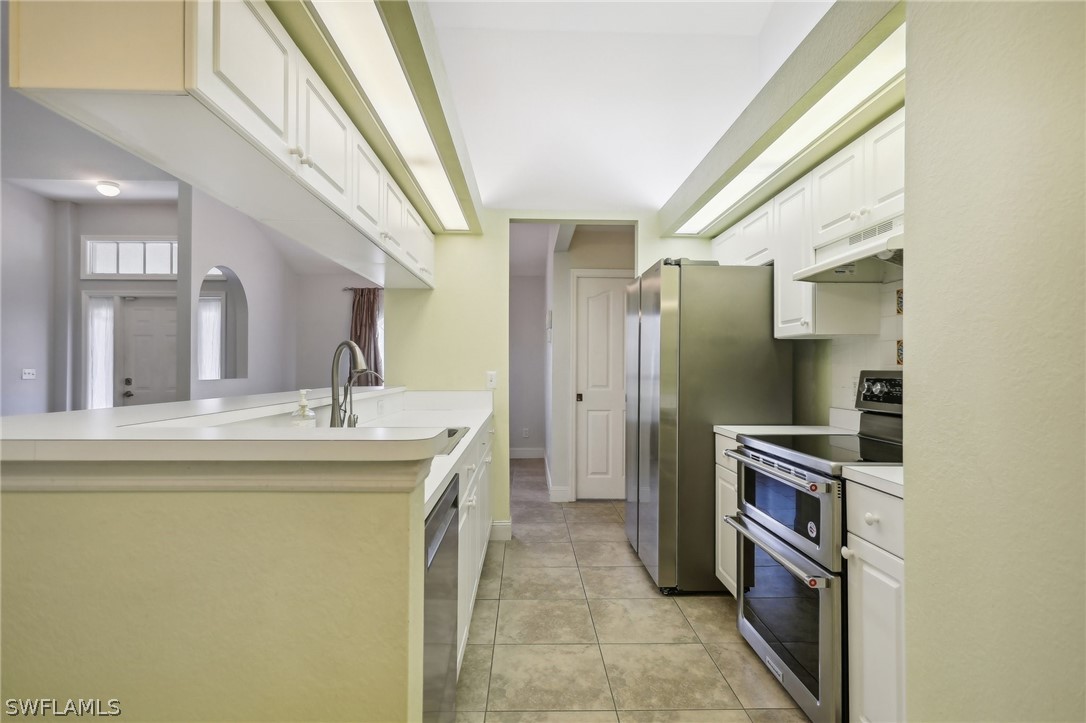 18364 Camellia Road Fort Myers, FL 33967 - Photo 14 of 48 a kitchen with stainless steel appliances granite countertop a refrigerator and a stove