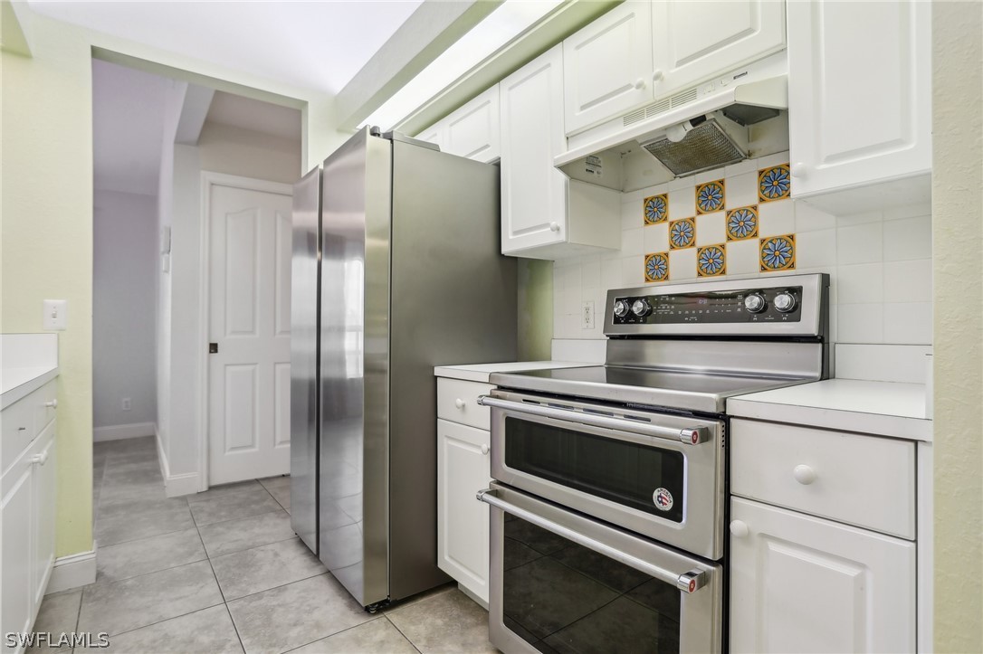 18364 Camellia Road Fort Myers, FL 33967 - Photo 15 of 48 a kitchen with stainless steel appliances a stove and a refrigerator