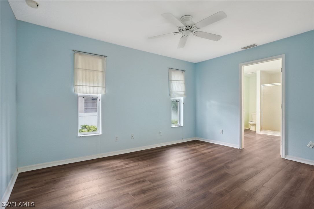 18364 Camellia Road Fort Myers, FL 33967 - Photo 17 of 48 a view of an empty room with a window and wooden floor
